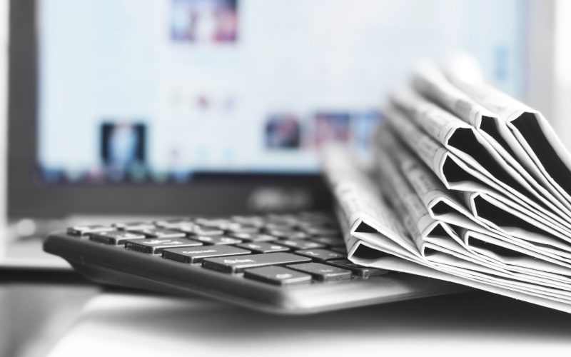 Newspapers and Laptop. Different Concepts for News - Social Network or Traditional Tabloid Journals. Data Sources - Electronic Screen of Computer or Paper Pages of Magazines, Internet or Papers