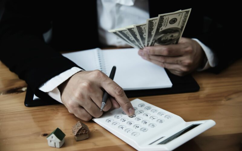 Business man show money bank note make financial plan invite people to sell or buy house and car - monetary properties loan credit insurance concept