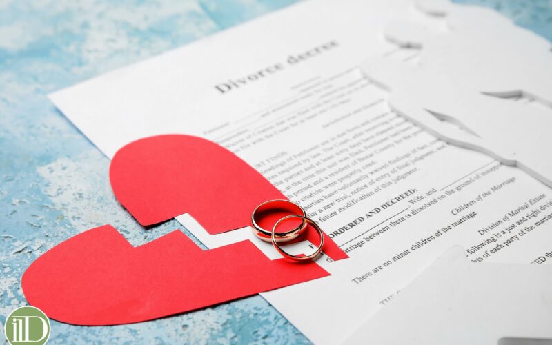 Broken heart with human figures and divorce decree on color background
